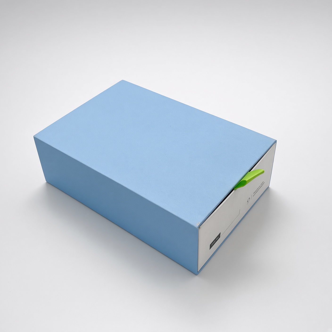 Light blue drawer box with a green pull ribbon
