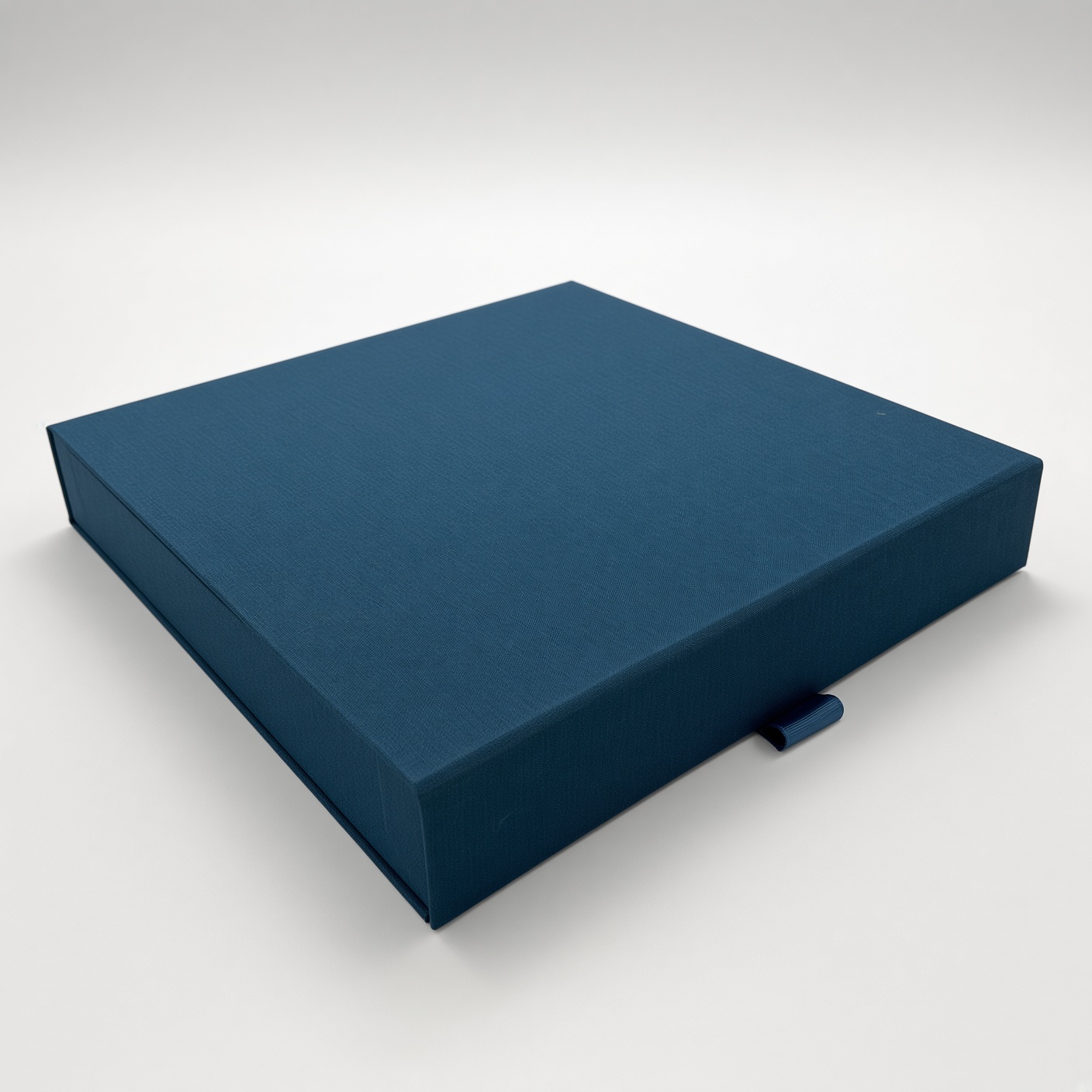 Dark blue premium magnetic box with a ribbon pull for opening