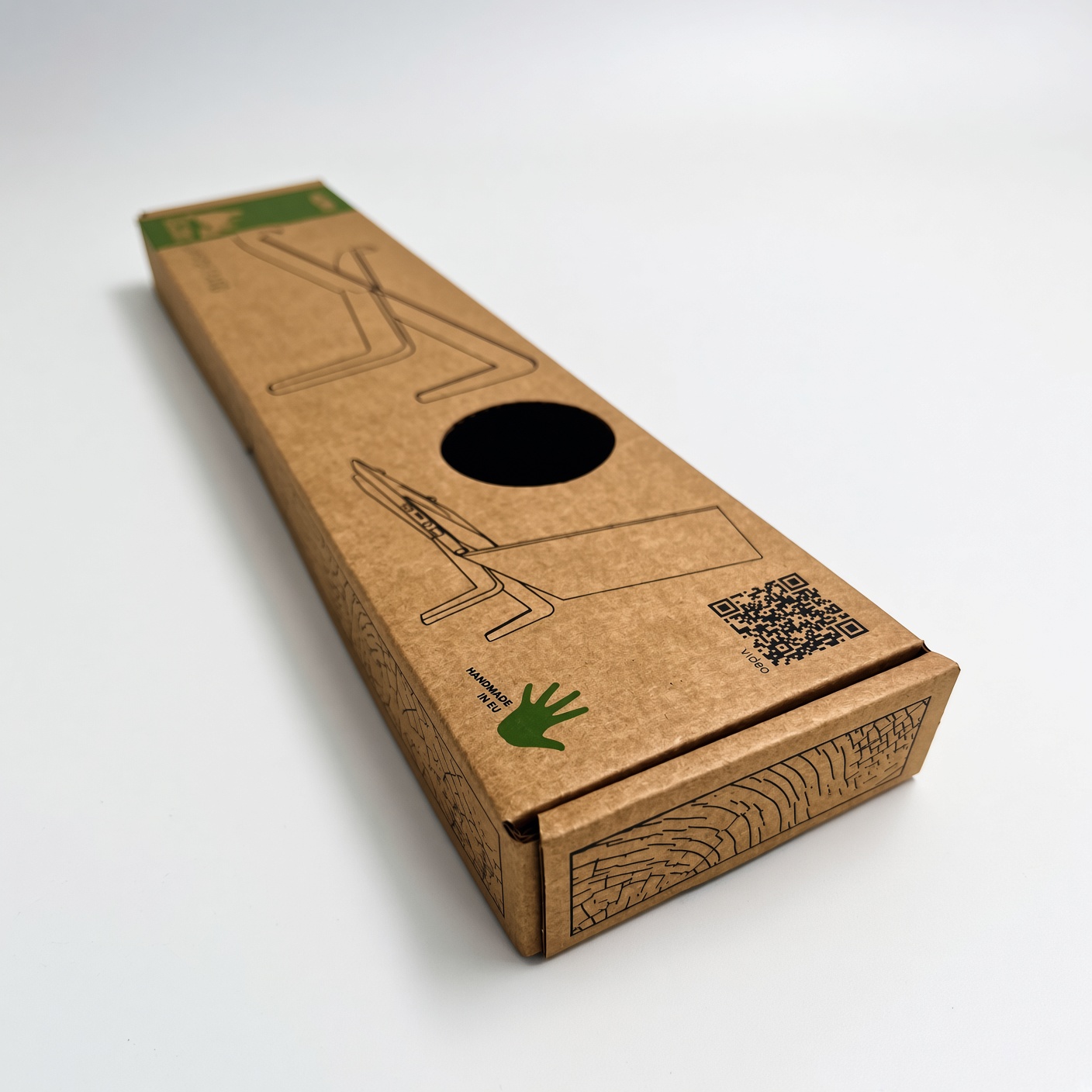 Elongated brown corrugated box with a die-cut window and green screen printing