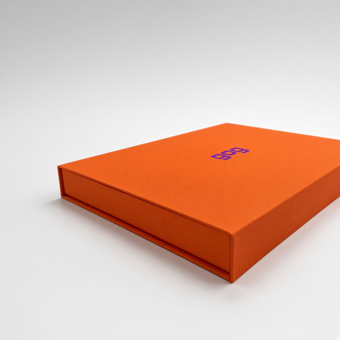 Orange magnetic box with a foil-stamped logo