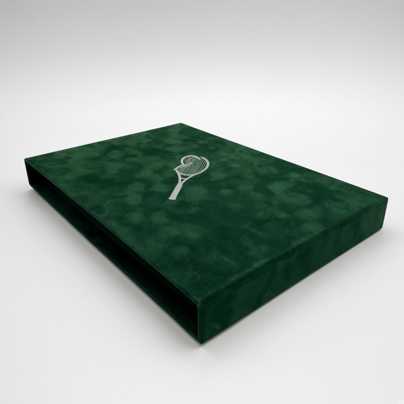 Dark green velvet-textured book slipcase with a silver foil tennis racket