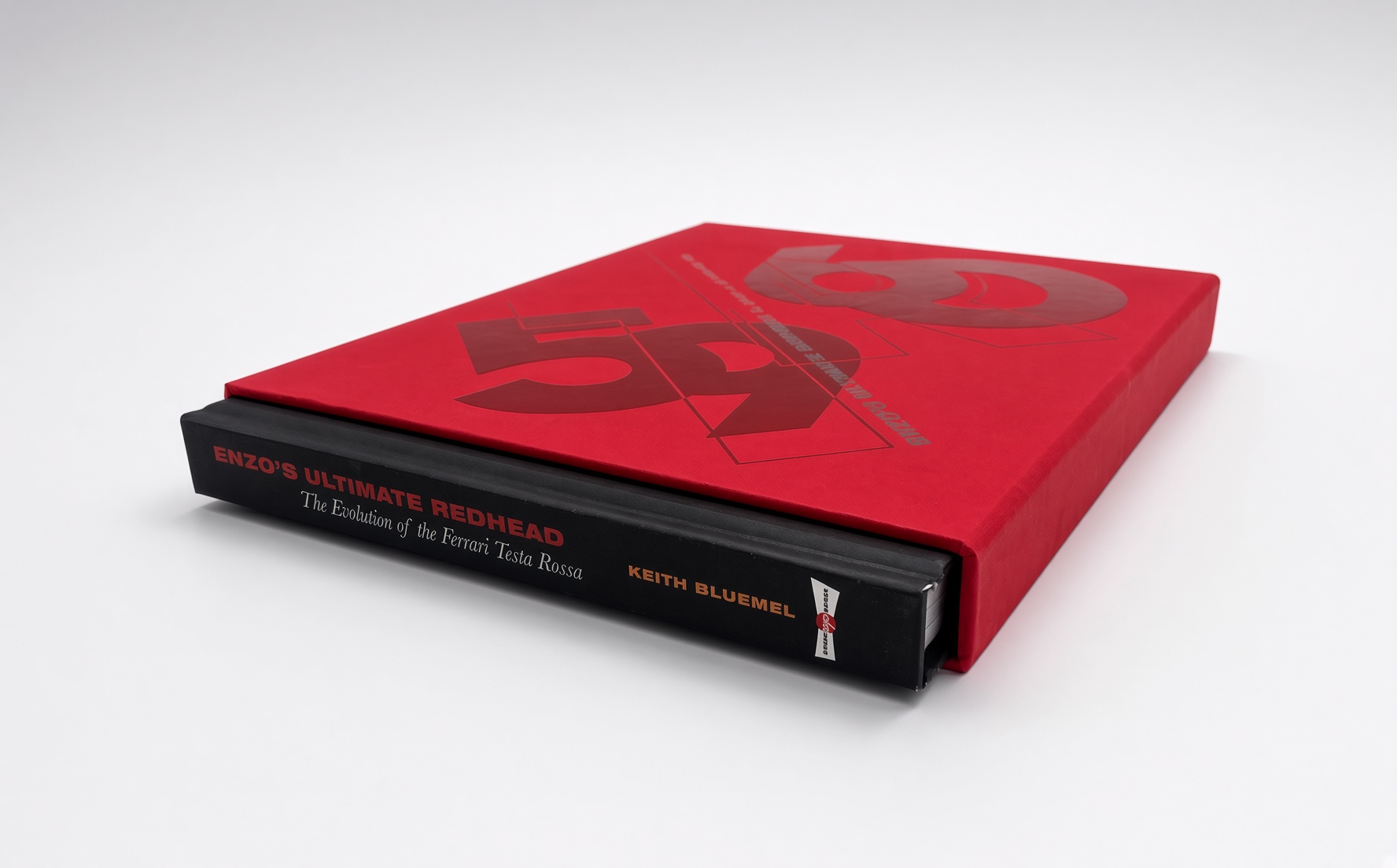 Red book slipcase with embossing, holding a hardcover book
